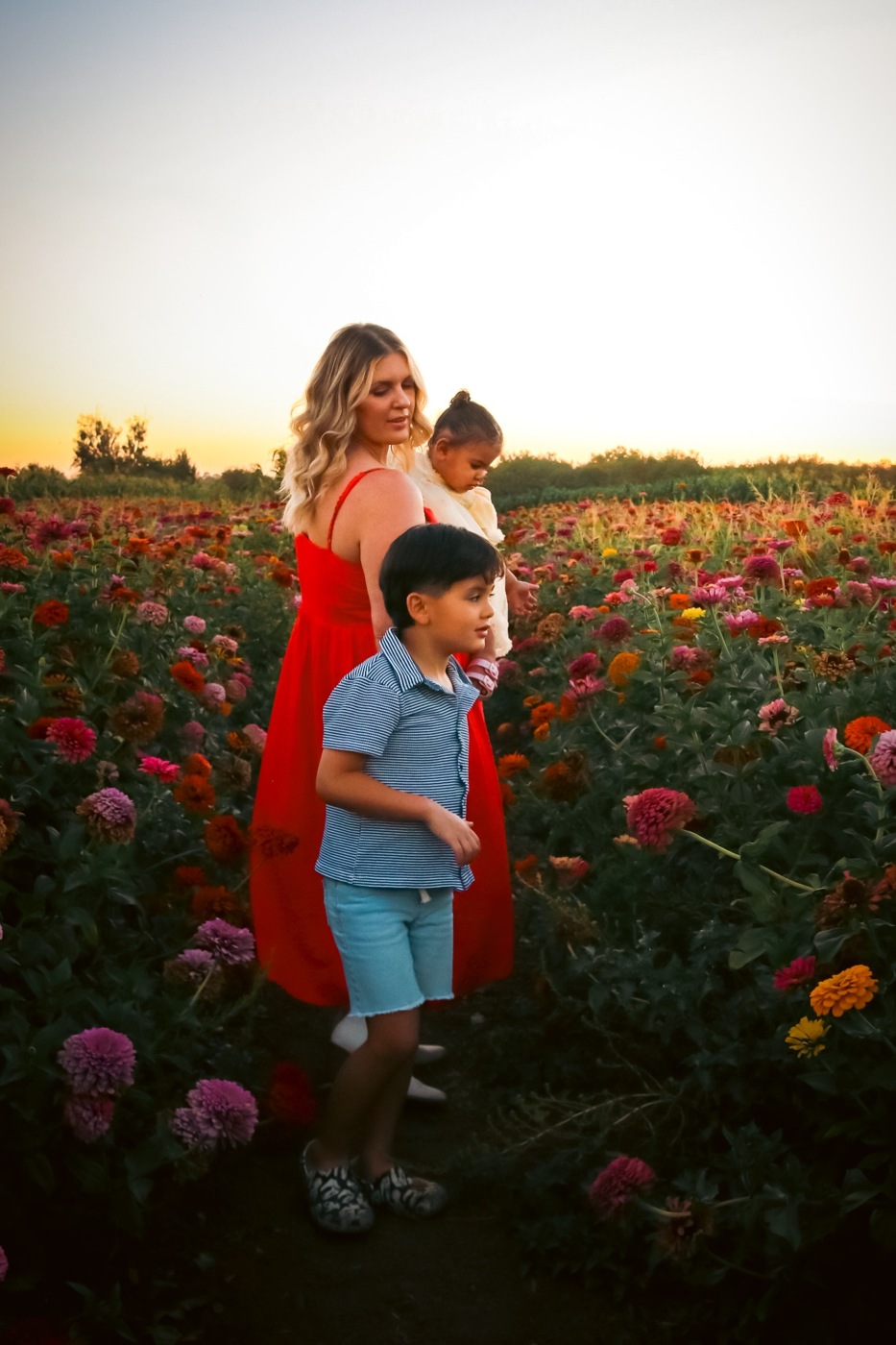 Lauren with her children among colorful flowers