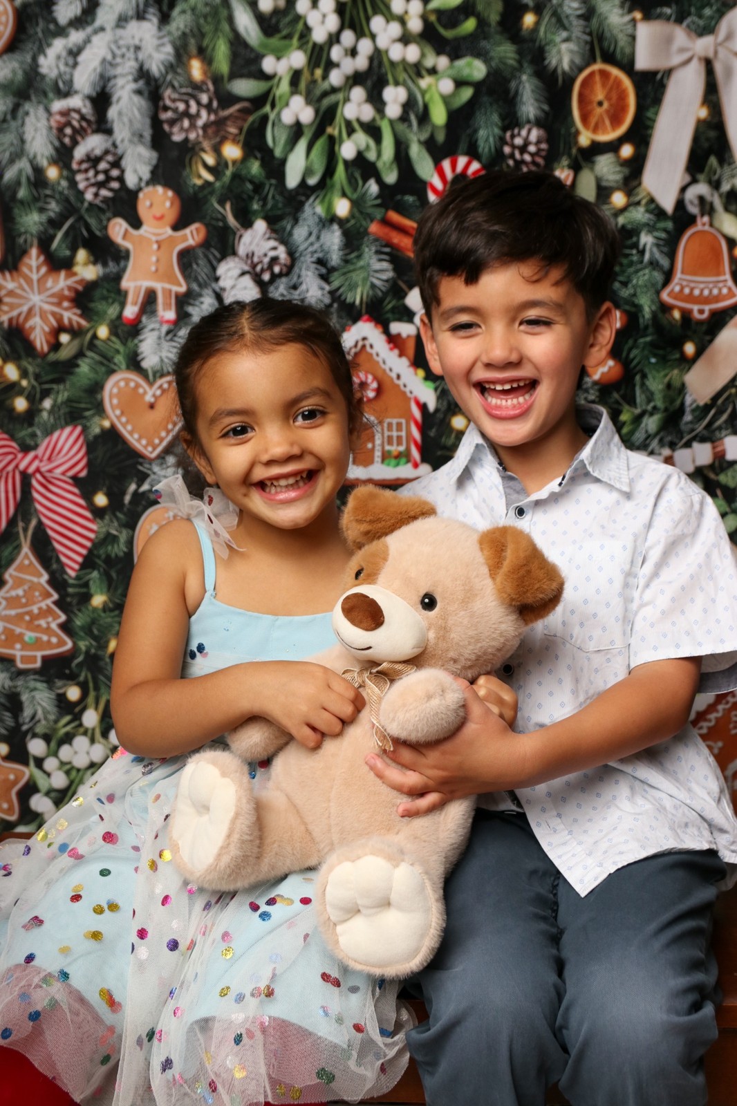 Siblings laughing in a holiday set